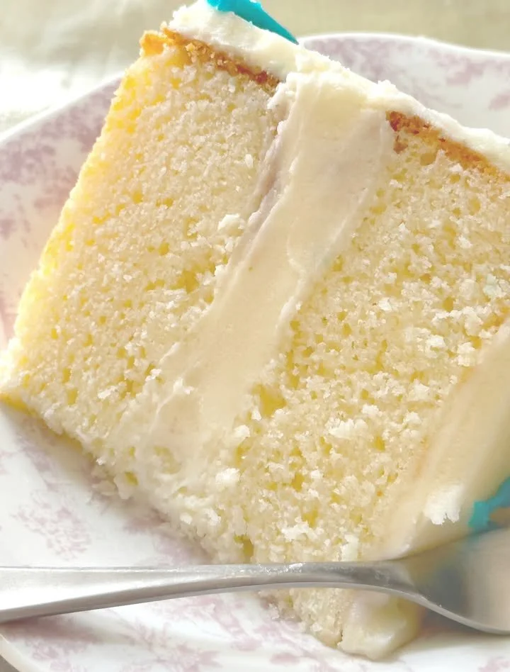 Homemade copycat Costco vanilla cake with frosting on a plate