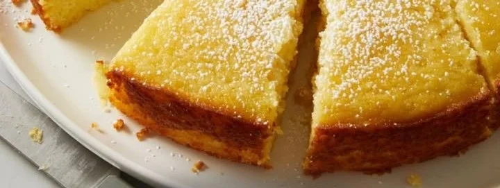 Deliciously moist Lemon Ricotta Cake topped with lemon glaze and fresh berries.