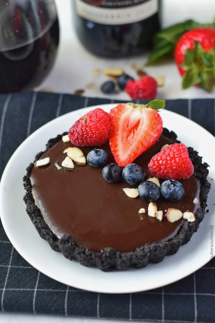 Delicious mini chocolate tarts displayed on a white plate