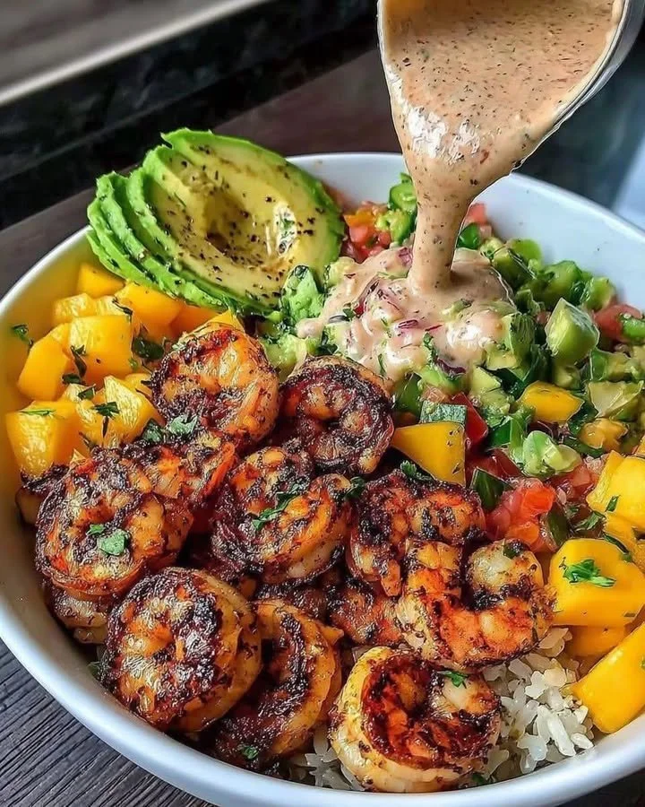Shrimp avocado bowls with mango salsa and lime-chili sauce.