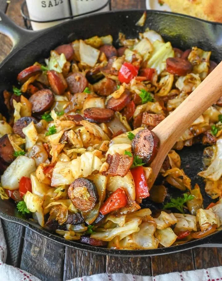 Plate of Southern fried cabbage with sausage, garnished and ready to serve.