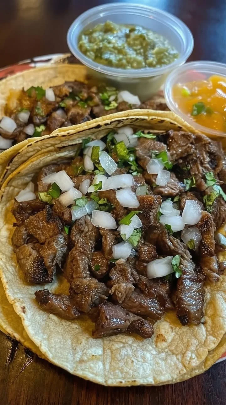 Delicious street tacos featuring grilled beef, garnished with fresh toppings.