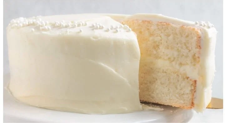 A beautifully decorated white velvet cake with cream cheese frosting